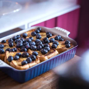 -casserole-dish-filled-with-golden-baked-French-toast-topped-with-blueberries