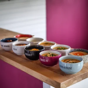 A-collection-of-soup-bowls-representing-the-regional-favorites-with-labels-highlighting-their-countries-of-origin