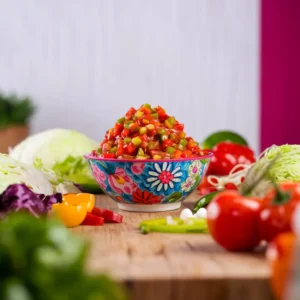 A-colorful-bowl-of-chow-chow-relish-surrounded-by-the-raw-ingredients-like-chopped-cabbage-peppers-and-tomatoes