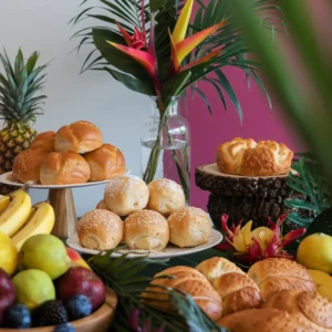 A-festive-table-featuring-various-Hawaiian-breads—sweet-rolls-taro-bread-and-pineapple-loaves—surrounded-by-tropical-fruits-and-vibrant-flowers