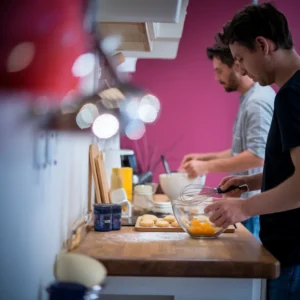 A-kitchen-scene-featuring-eggs-being-whisked-and-biscuits-being-prepared-emphasizing-the-hands-on-approach-to-fast-food-breakfast-development