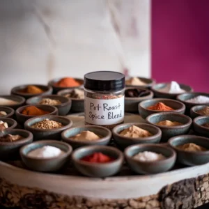 A-rustic-display-of-the-seasoning-ingredients-in-small-bowls-arranged-around-a-jar-labeled-Pot-Roast-Spice-Blend