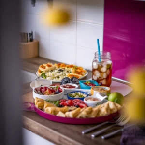 A-vibrant-picnic-setup-featuring-a-mezze-platter-spanakopita-orzo-salad-and-a-mason-jar-of-iced-herbal-tea